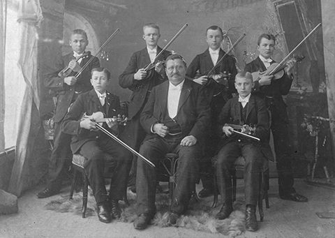 Eduard Fürst, umgeben von seine Schülern. Alle Schüler mit Violine.